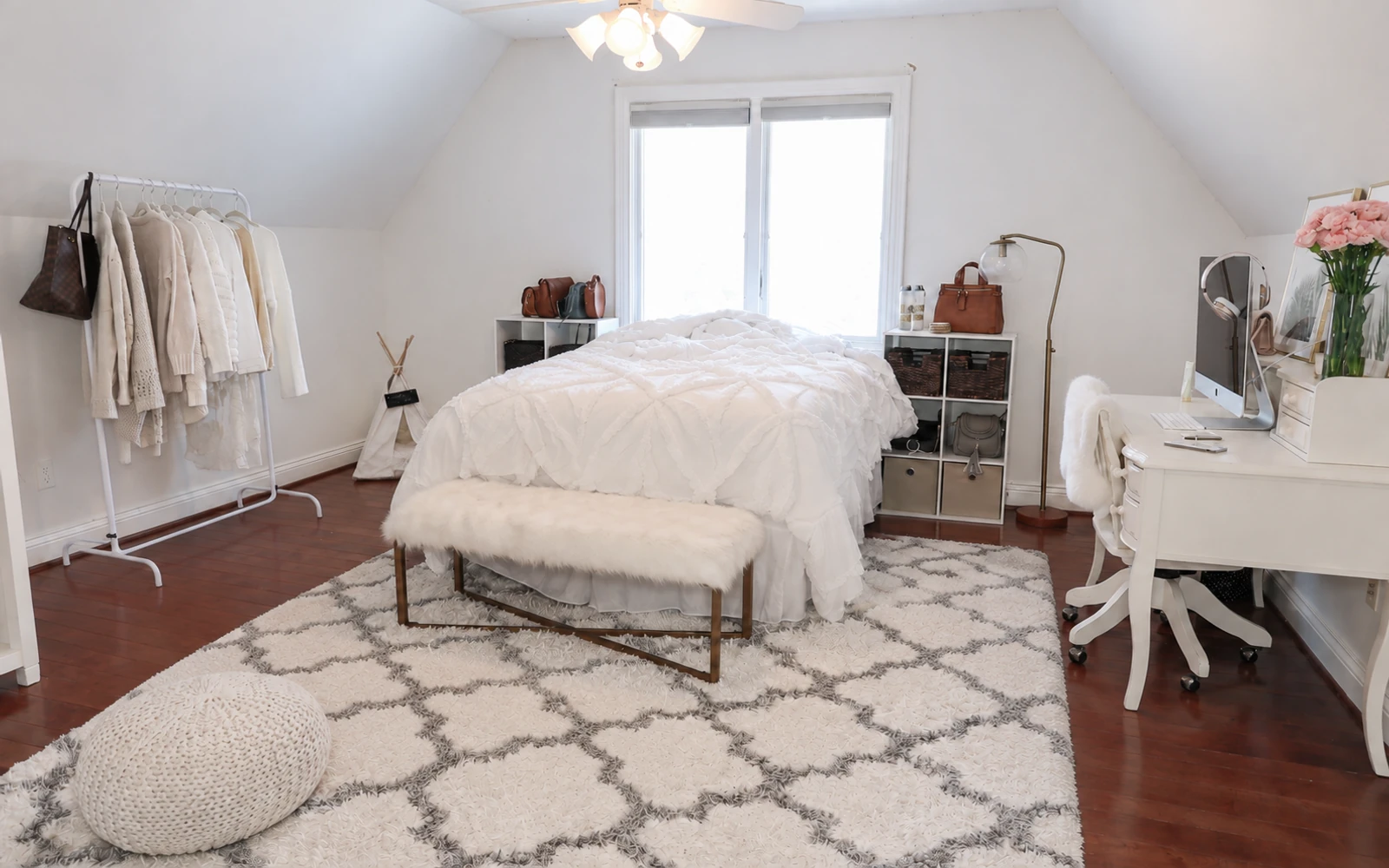 Bedroom with a sloped ceiling, bed and clothes rail — after